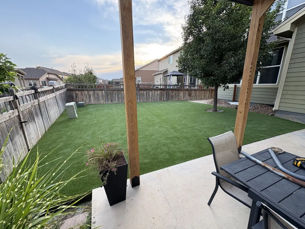 A finished artificial turf back lawn with a covered patio and fenced yard
