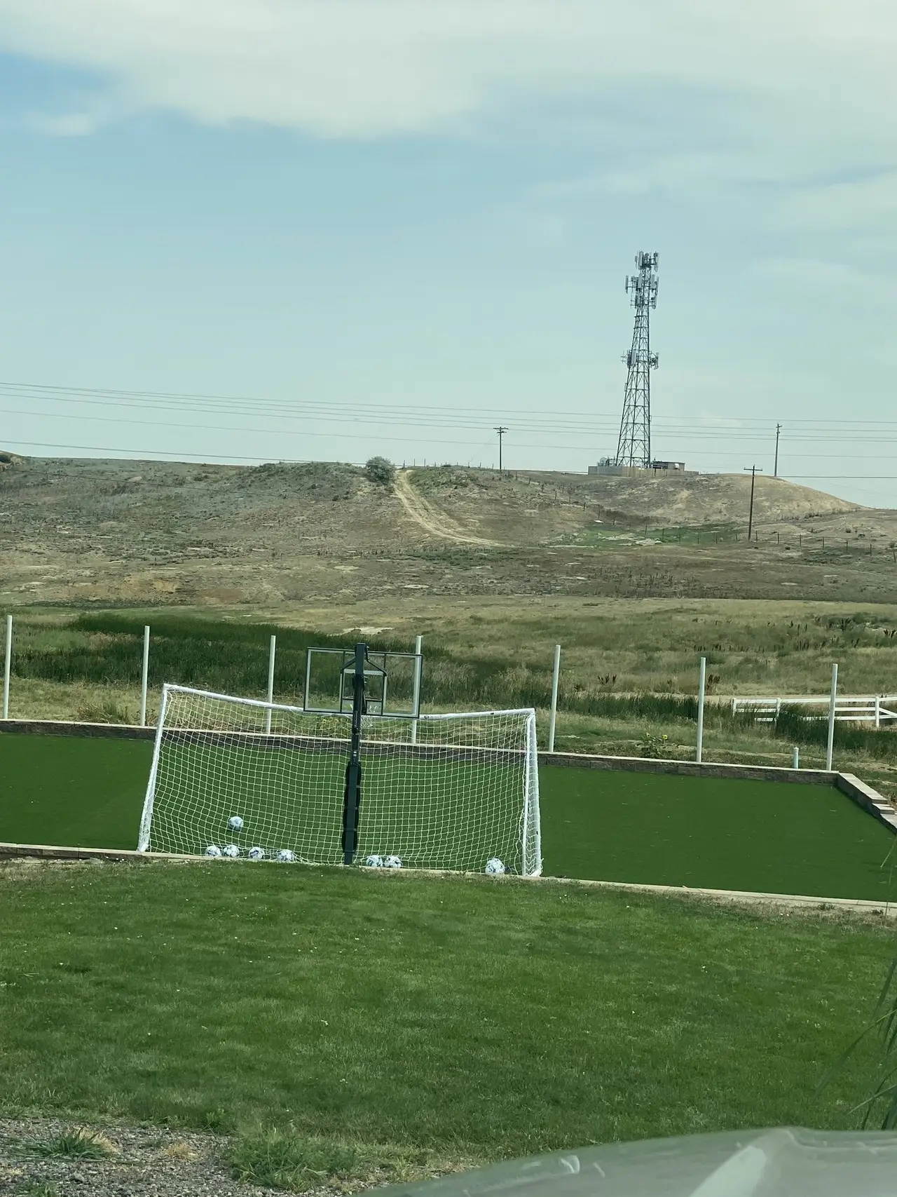 Practice nets and goals set on a turf field